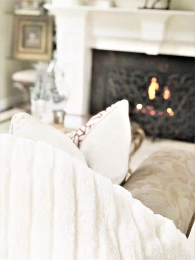 White fur blanket by fire