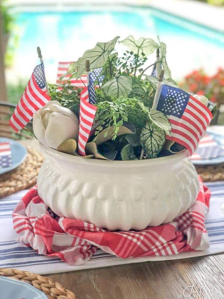 Patriotic table centerpiece with small flags and real white flowers