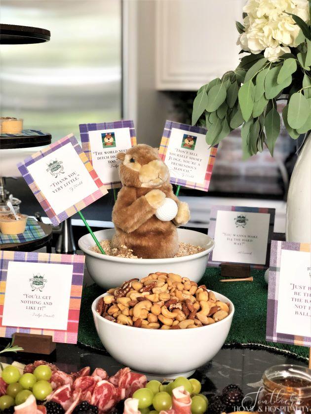 Golf theme party food with gopher in bowl and movie quote signs