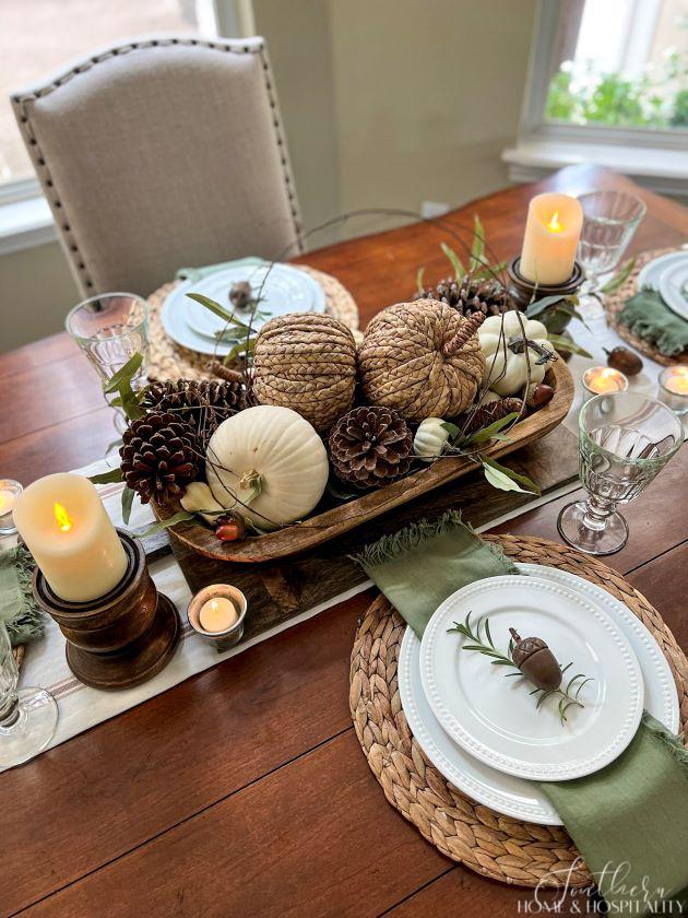 fall dough bowl with pumpkins and pine cones, wood candle holders with flameless candles in a casual fall tablescape