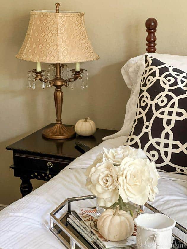 guest room bedside table with lamp and pumpkin
