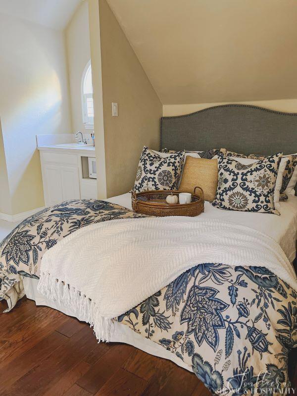 guest bedroom bed and kitchenette