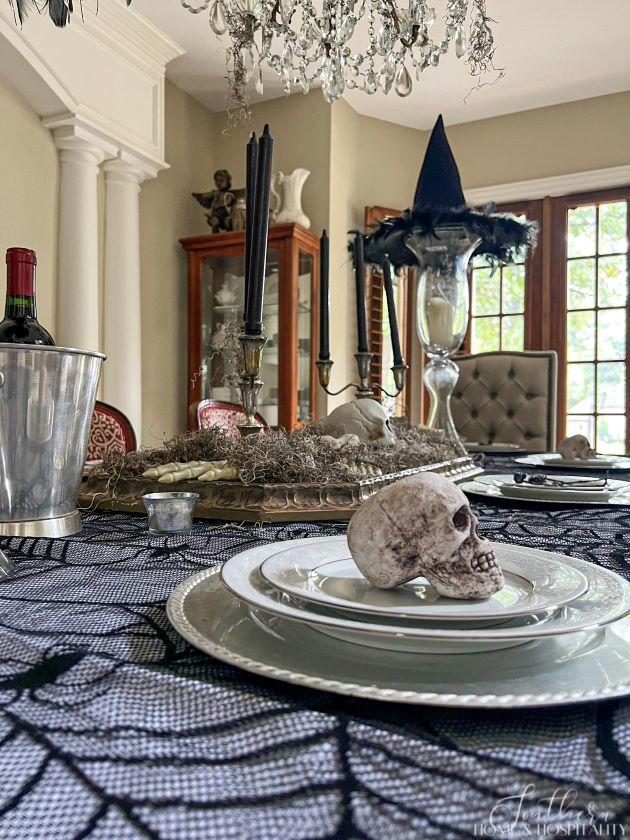 spooky chic gothic halloween dining room place setting with skull