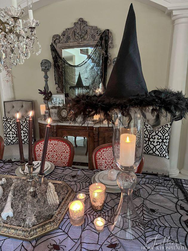 spooky chic dining table with witch hat and candles