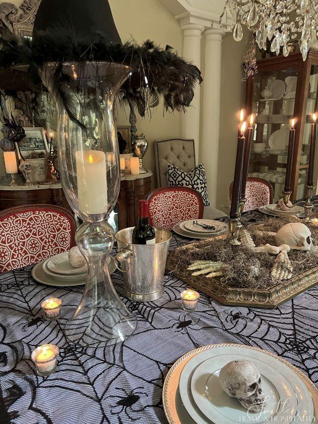 spooky chic dining table with witch hat and candles