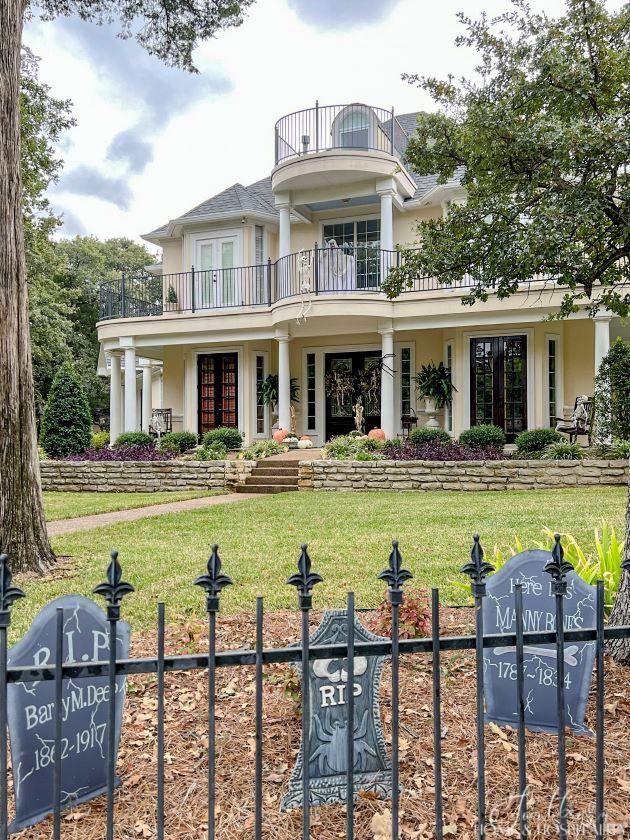 porch and balcony decorated for Halloween, funny tombstones in yard