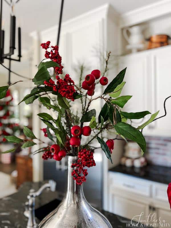 red berries and greenery in vase