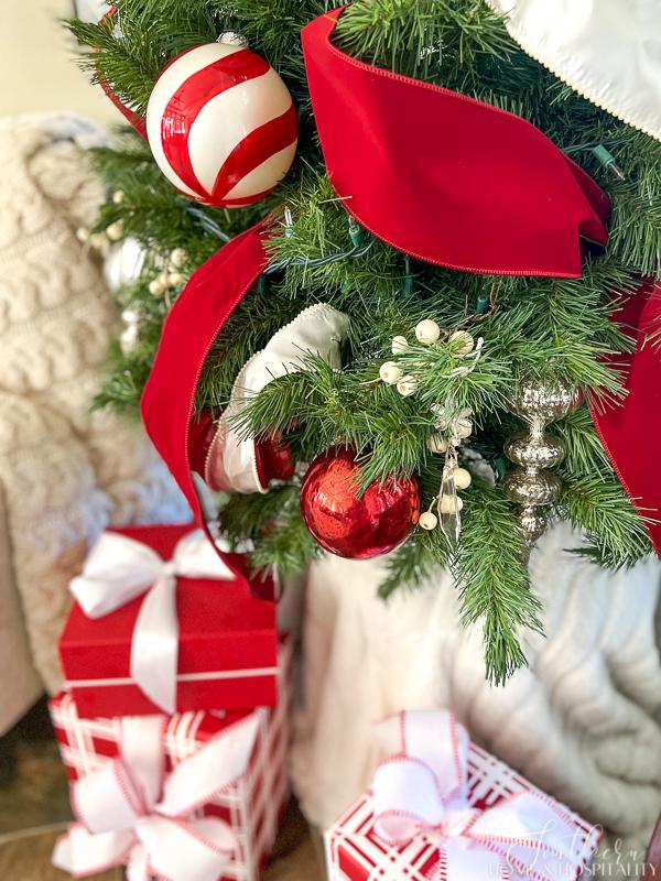 red and white ornaments and ribbon on Christmas tree