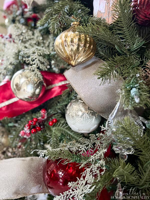 Christmas tree decorated in red, silver, champagne and white ribbon and ornaments