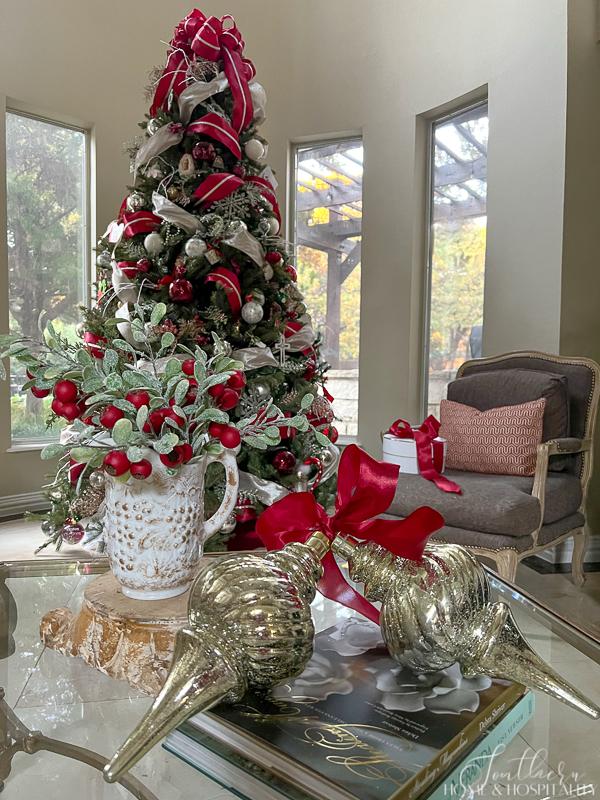 Red berries with frosted leaves in a white pitcher