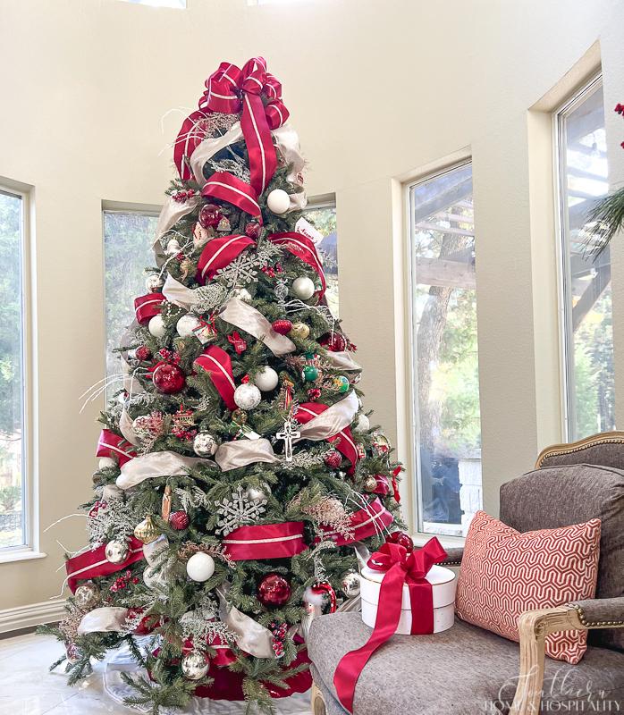 Christmas tree decorated in red, silver, champagne and white ribbon and ornaments