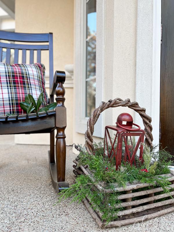 porch rocker with plaid pillow basket with lantern and greenery