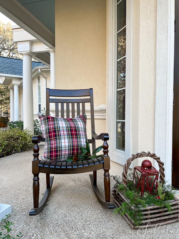porch rocker with plaid pillow and lantern