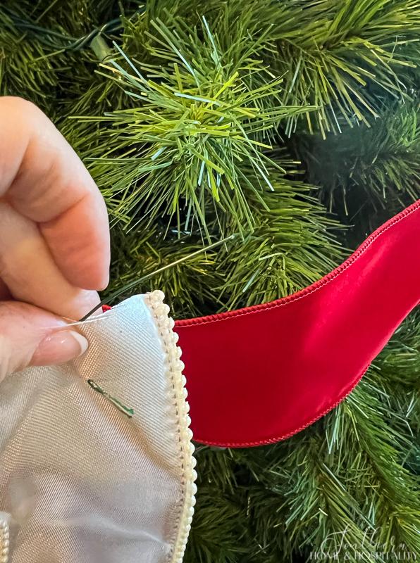 Using wire ornament hooks to attach ribbon to tree