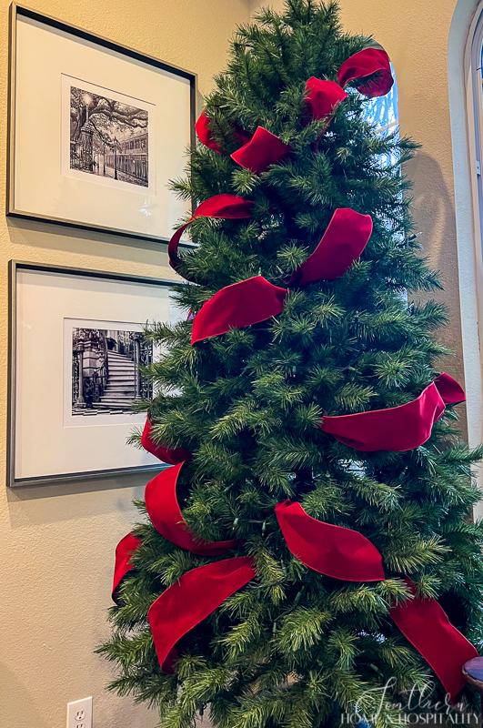 putting ribbon on small christmas tree