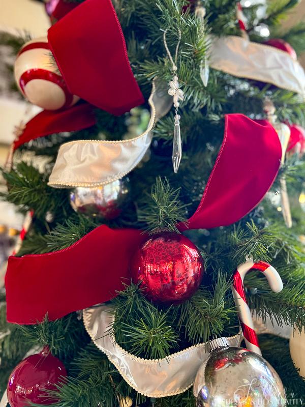 Red and white ribbon and ornaments on Christmas tree