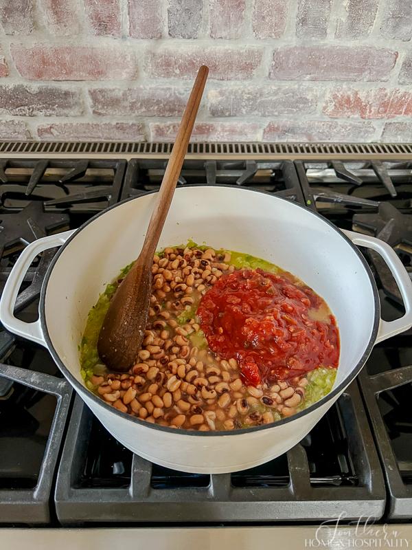 black eyed peas and picante sauce in pot on stove