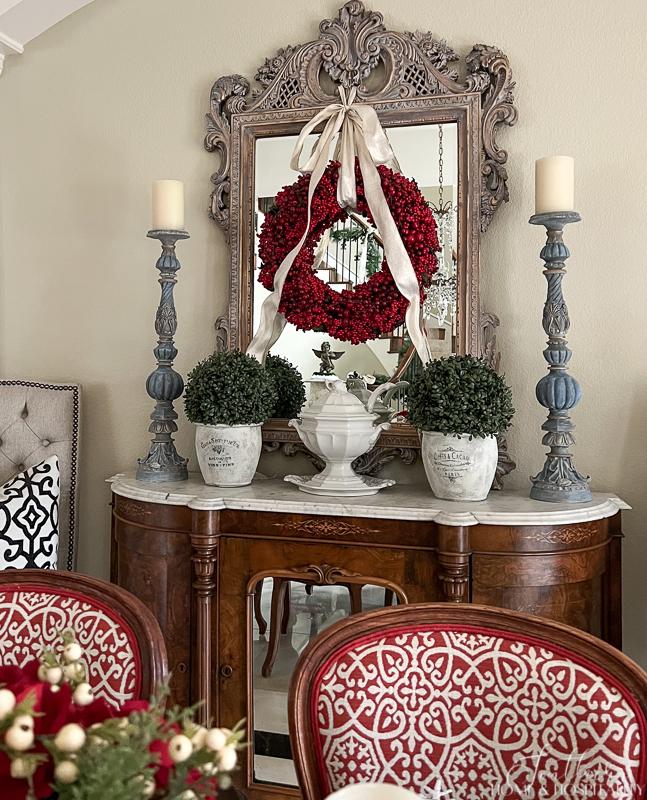 French buffet red berry wreath on mirror