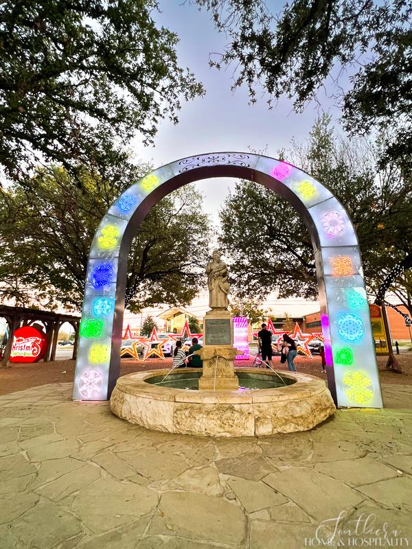 Lighted arch over statue in downtown Grapevine Texas