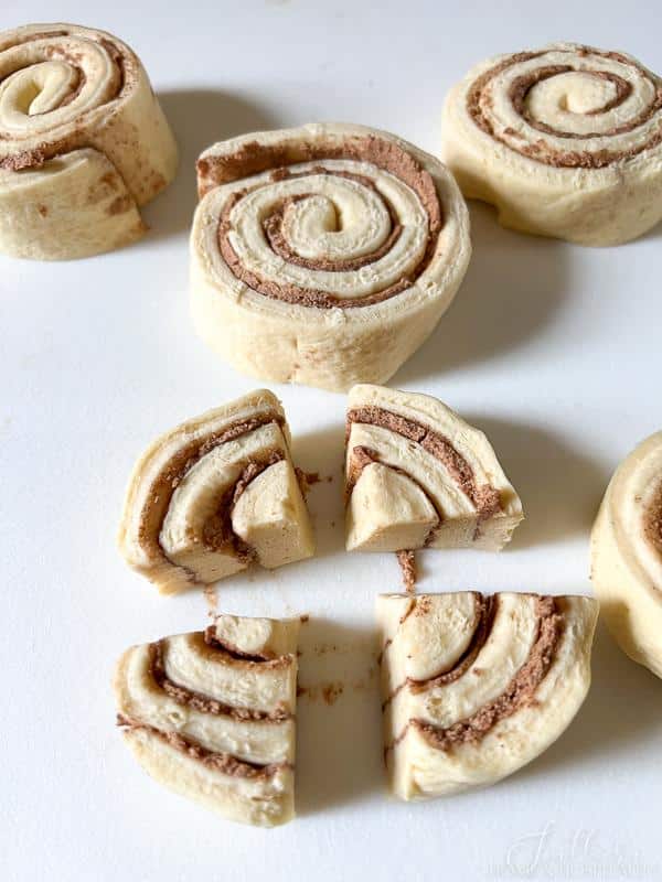 uncooked cinnamon rolls cut into quarters