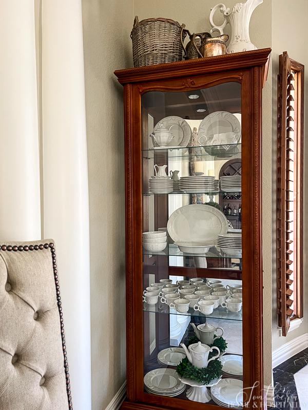 Decorating with white dishes with ironstone in a curio cabinet