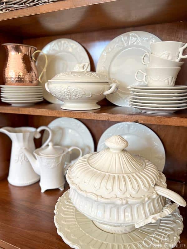 White dishes in a wood hutch