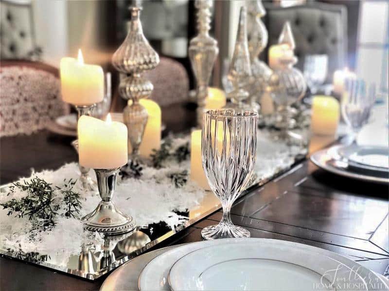 Winter tablescape with candles and snow