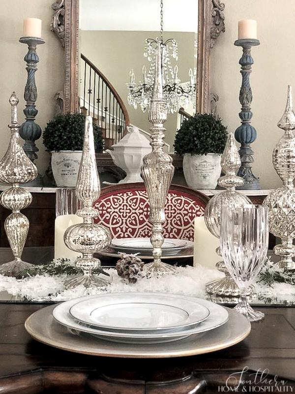 Mercury glass finials in a winter tablescape in a French country dining room