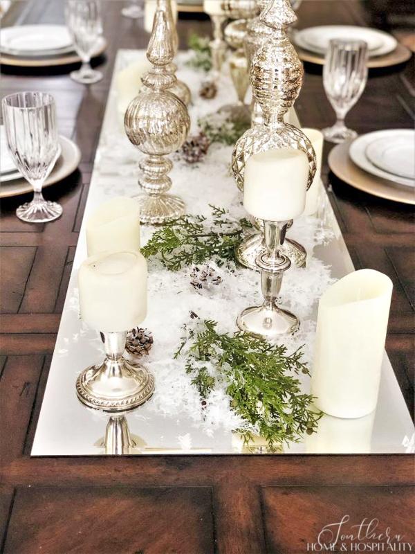Winter silver and white centerpiece on a mirror
