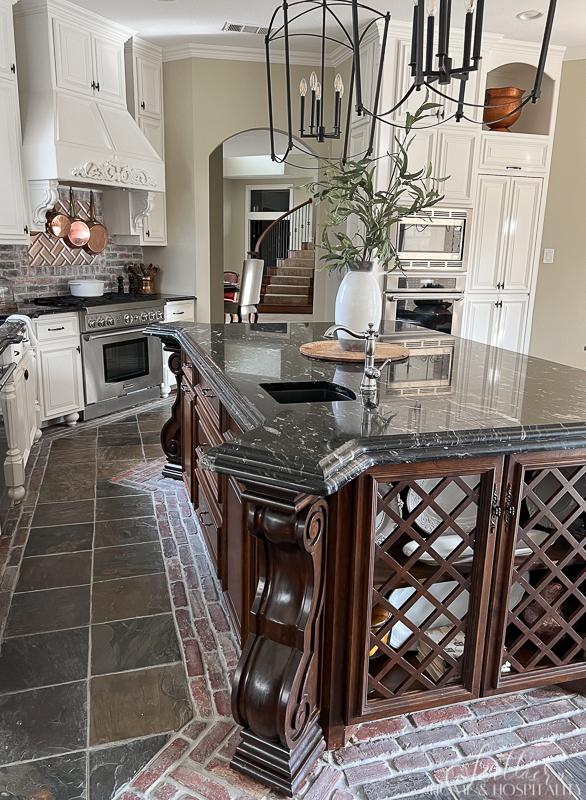 Kitchen island with lattice doors, brick and slate floor