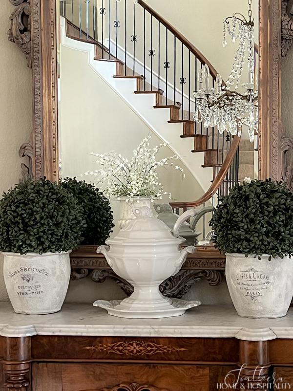 White ironstone soup tureen decorating a dining room sideboard