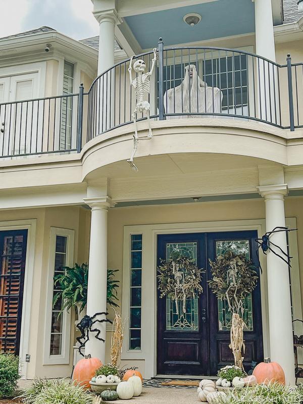 Balcony decorated for Halloween with skeleton and ghost