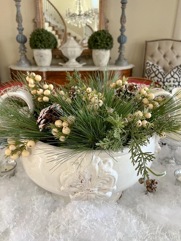 Winter table centerpiece with pine, cedar, and white berries