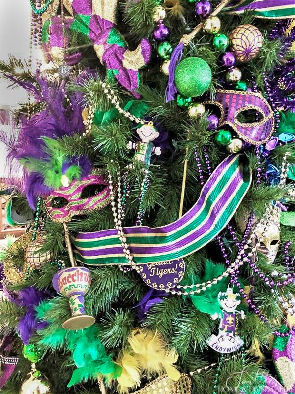 top of a Mardi Gras Christmas tree decorated with purple (…