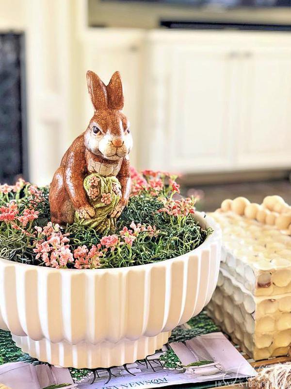 Easter bunny figurine and pink flowers in a white bowl
