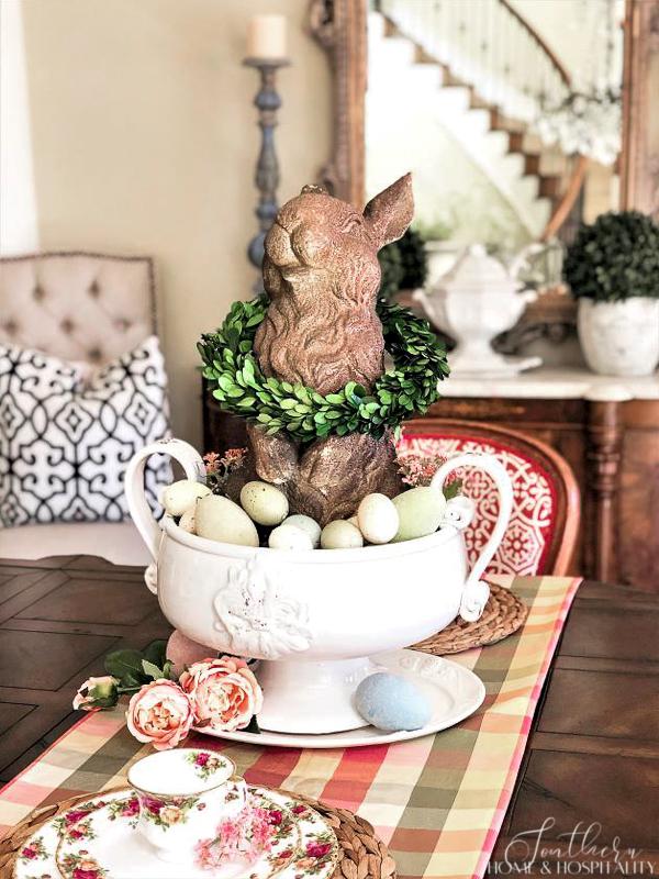 spring dining table centerpiece with bunny and eggs in a pedestal bowl