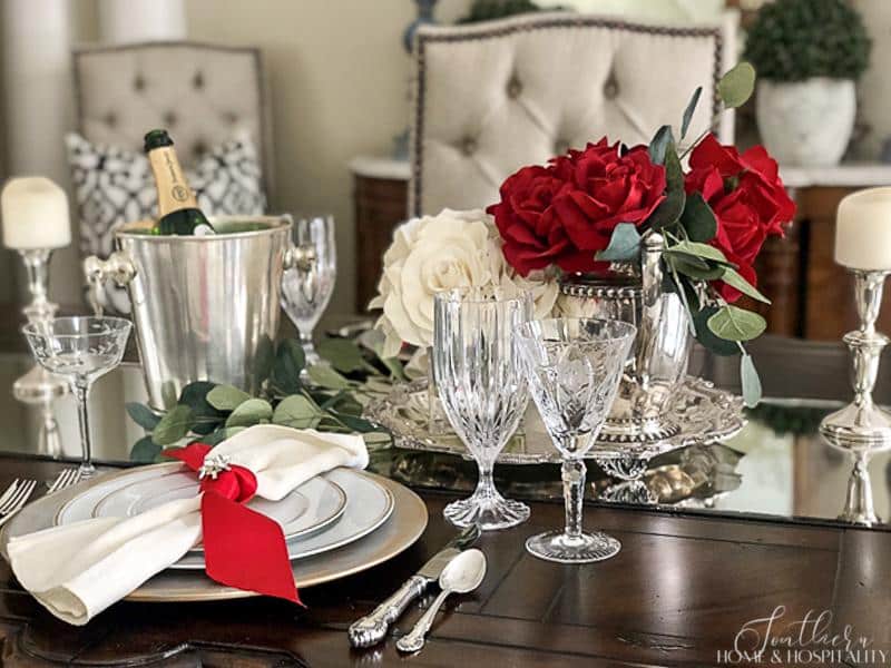 Valentine's Day table with red and white roses and silver
