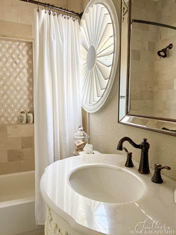 shower with marble tile mosaic, matelasse shower curtain, bronze faucets