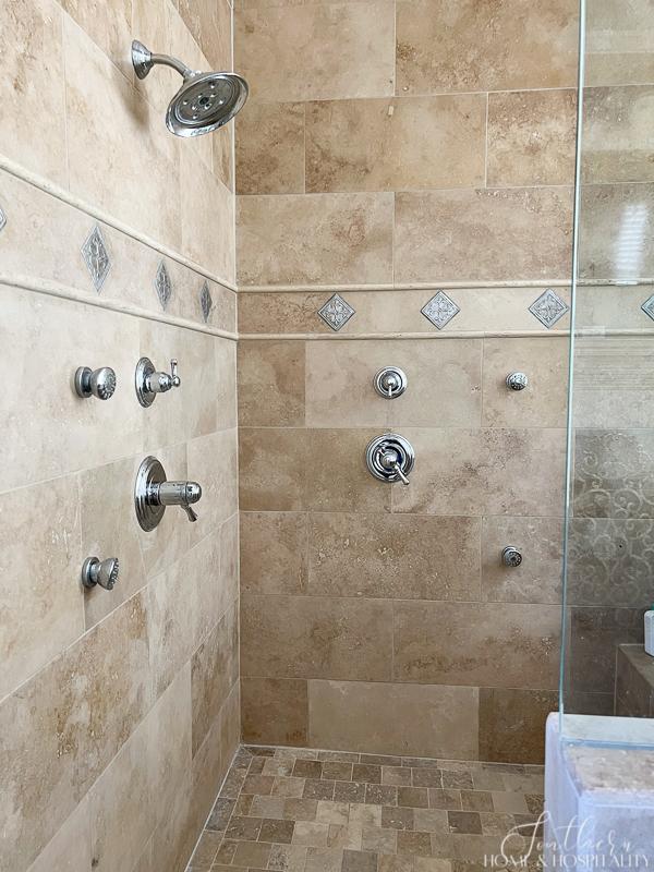 travertine shower with accents and body sprays