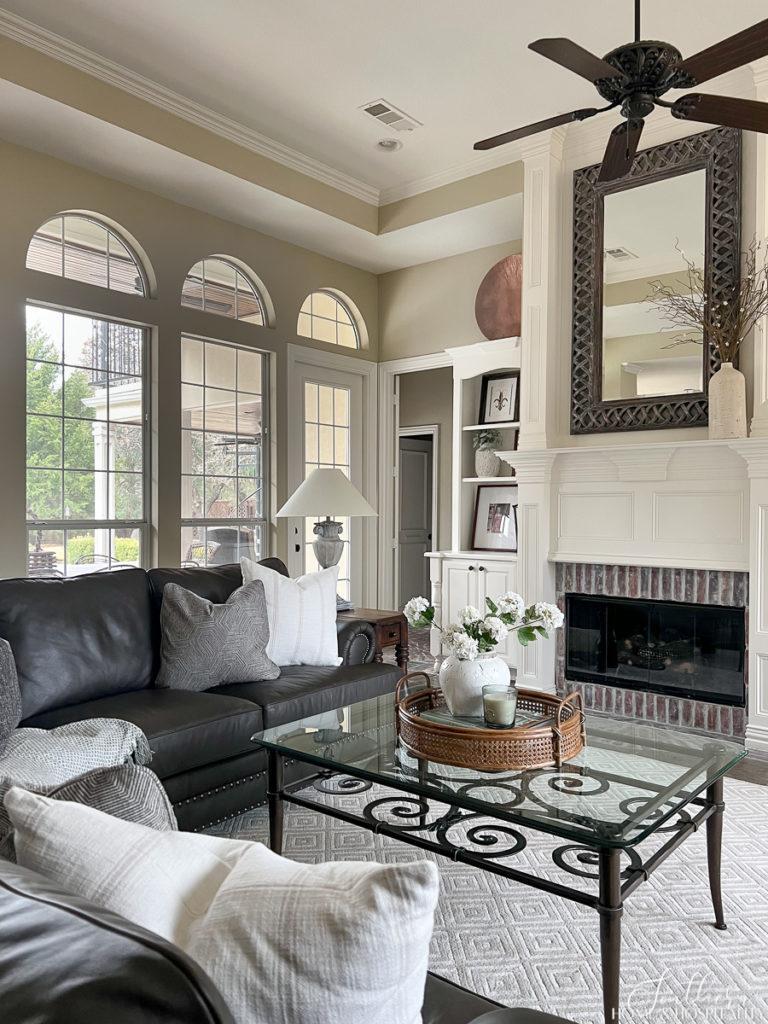 Southern traditional family room with painted wood and brick fireplace and builtins and leather sectional