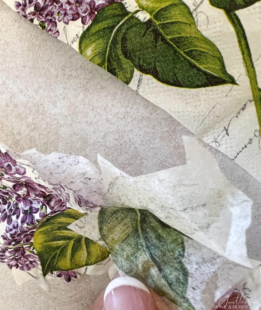 Tearing apart spring floral napkin to decoupage onto flower pot