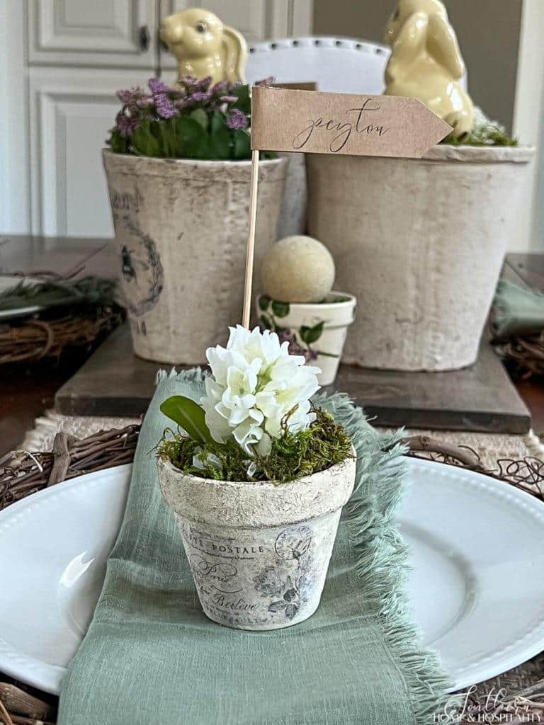 Vintage garden pot used as place card with French transfer, purple hyacinth, and plant marker name card