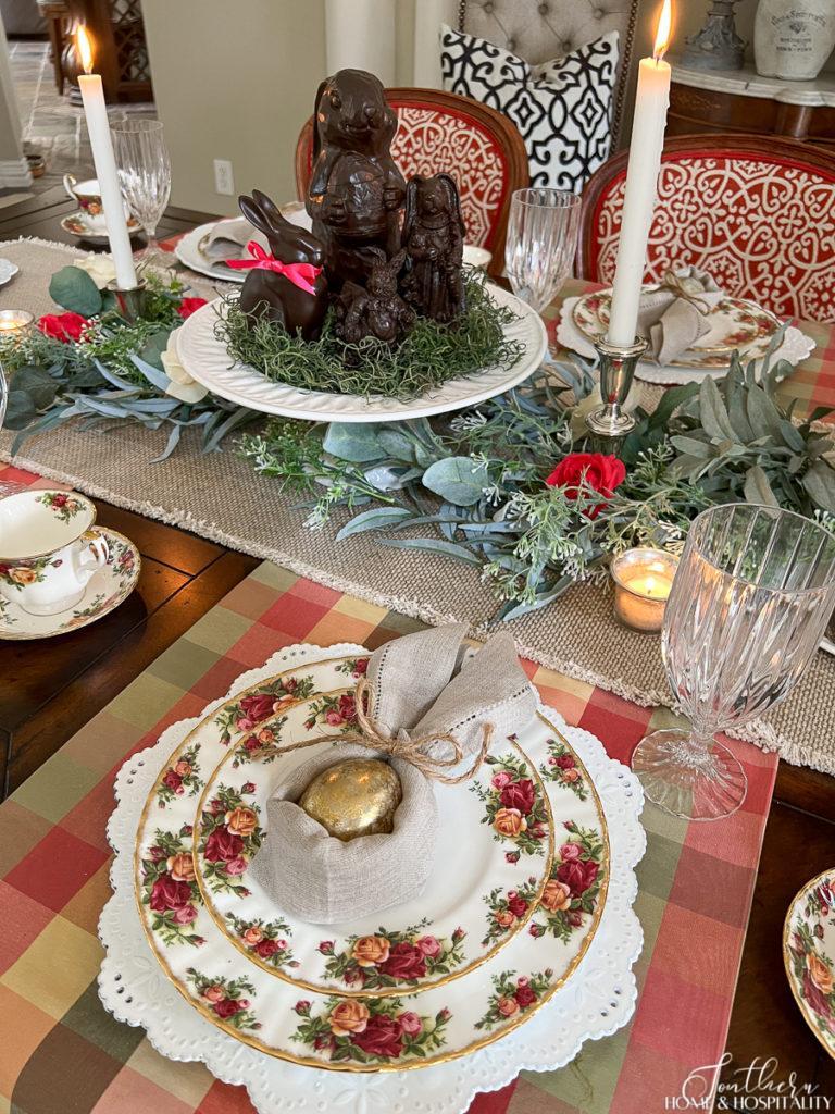 Easter English garden table setting with chocolate bunnies, flower garland, Old Country Roses china, and bunny napkin fold