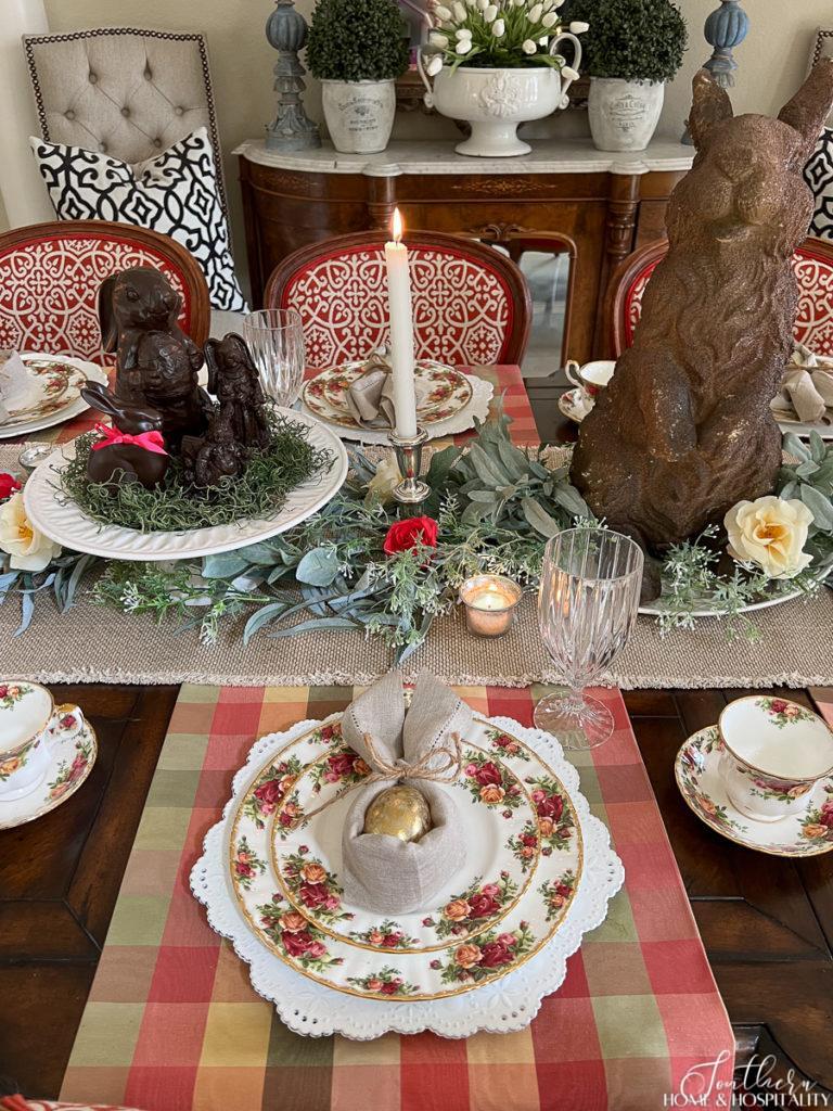 Easter dining table with Old Country Roses china, bunny napkin fold, and faux chocolate bunnies