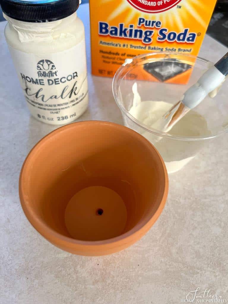 Orange clay pot with antique white paint and baking soda