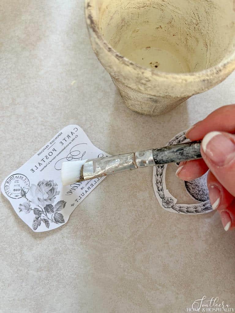 Brushing Mod Podge onto printed side of graphic