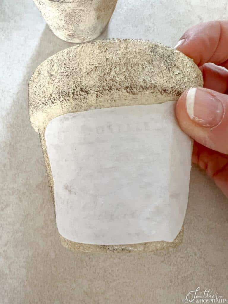 Gluing the image image to the flower pot with Mod Podge