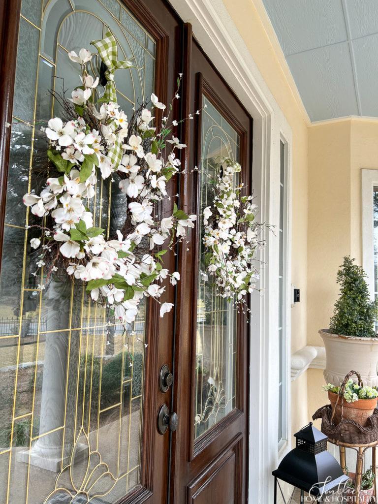 Dogwood and cherry blossom spring wreaths on double wood front doors