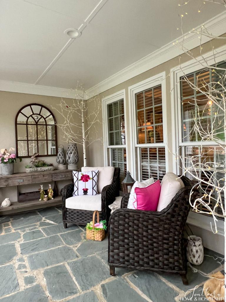 Front porch decorated for spring with pink accents
