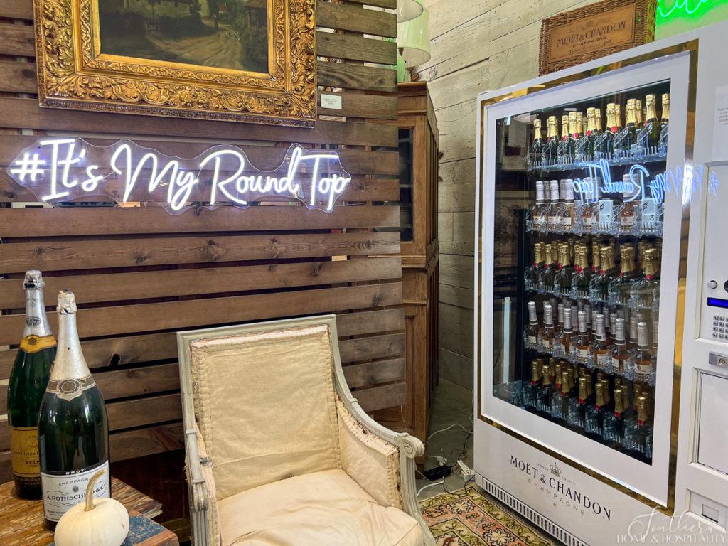 Champagne vending machine and Round Top neon sign